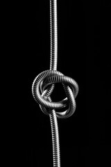 metal rope tangled on black background