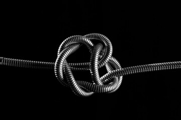 metal rope knot isolated on black background