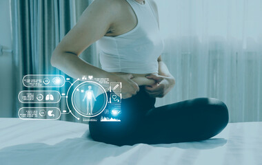 Fototapeta premium Beautiful fat woman with tape measure She uses her hand to squeeze the excess fat that is isolated on a white background. She wants to lose weight, the concept of surgery and break down fat under the