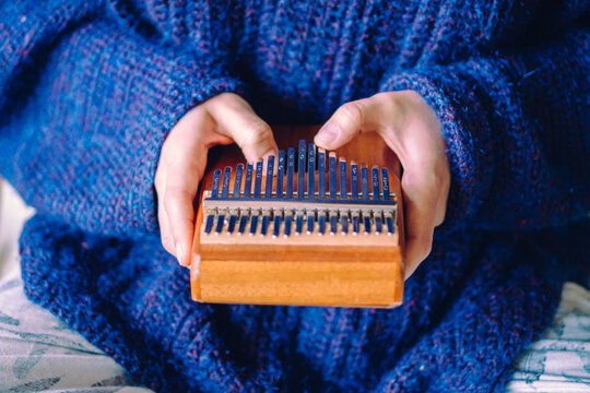 unrecognizable woman music playing a kalimba. close up