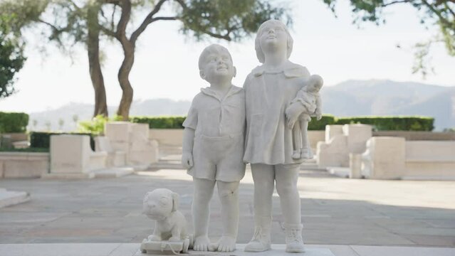 Statue of kids and a dog in the cemetery 
