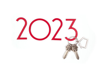 background 2023 New year and Christmas. Banner with keys and keychain. Real estate purchase concept. Sale, rent. Get the keys to the apartment as a gift