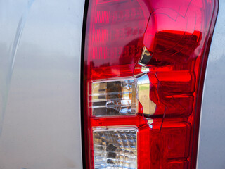 Close up of  rear car light broken by crash accident. Concept of auto accident, motor Insurance