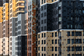 Multicolored facade of panel residential building with protruding architectural parts. Establishing...