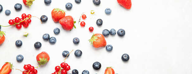Various fresh berries on neutral background.