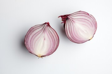 Two halves of a red onion on a white background