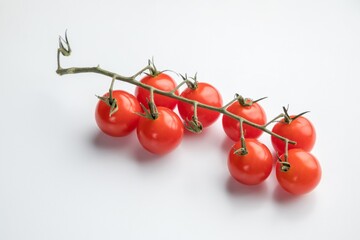 A branch of cherry tomatoes on a branch. White background.