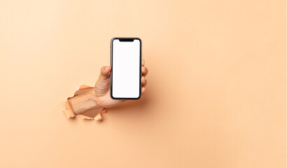 man hand holding a blank screen smart phone on a brown background.