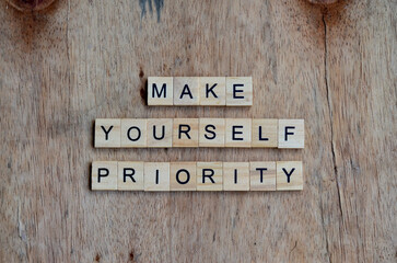make yourself priority text on wooden square, motivation quotes