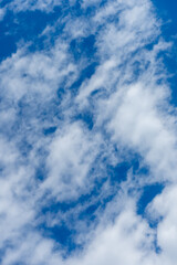 Fototapeta premium White clouds in a bright blue sky