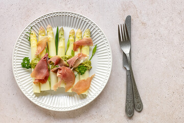 White asparagus with italian pesto and prosciutto ham. delicious dinner for spring season. traditional german dish. keto diet.