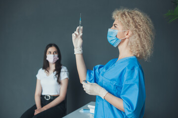 A nurse vaccinates a patient against a coronavirus infection. Coronavirus vaccination. Virus,...