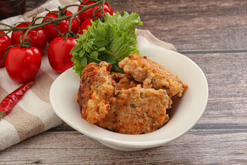Fried salmonn cutlet in the bowl