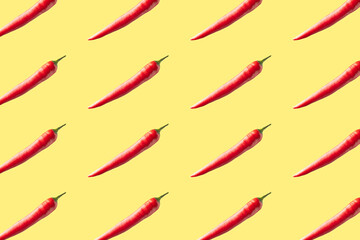 Red hot chili peppers on yellow background. Seamless repeating pattern.