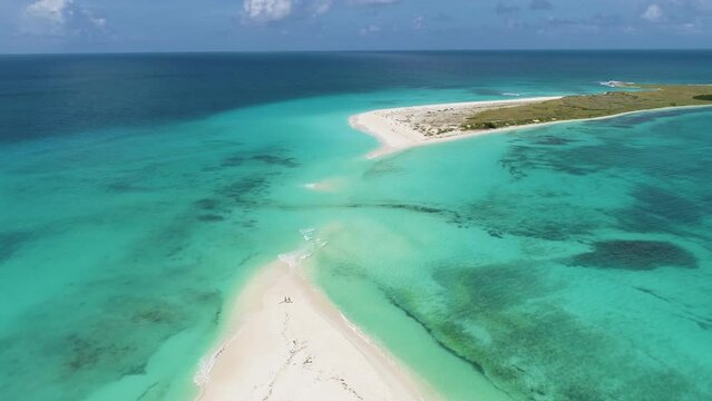 Aerial turn around peculiar isthmus of Cayo de Agua island, caribbean sea Los Roques