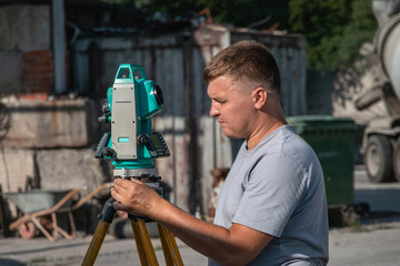A surveyor working with a total station. A surveyor with a total station at work on a sunny day....