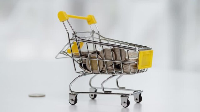 Motion stack of coins drop into cart.