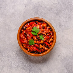 Chili Con Carne in bowl on grey background.