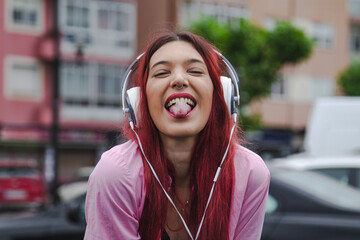 happy young girl with rebel expression and headphones