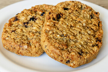 two soft flaky cookies on a white plate