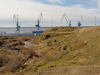Cranes in the baltic sea harbor of Paldiski, view from the hills of the former Peter the Great...