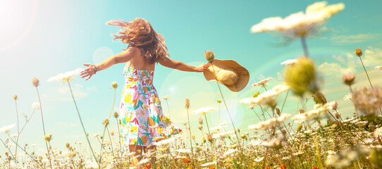 woman in a field with flowers- freedom, active, happiness concept