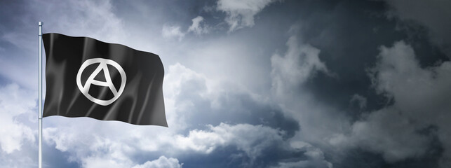 Anarchy flag on a cloudy sky