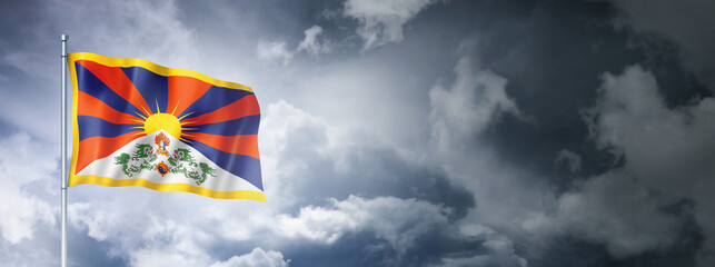 Tibetan flag on a cloudy sky