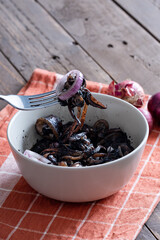 a tasty Filipino squid dish that uses Adobo method, also known as adobong pusit with a hint of spiciness topped with fresh red onions