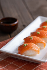 delicious fresh sashimi nigiri with wasabi on top and Japanese soy sauce on the side