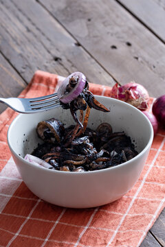 a tasty Filipino squid dish that uses Adobo method, also known as adobong pusit with a hint of spiciness topped with fresh red onions