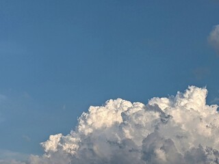 The blue sky and thunderheads are a summer landscape