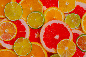 Colorful fresh citrus fruits slices - lemon, orange, grapefruit and lime - top view. Summer, natural, exotic, tropical and healthy food concept