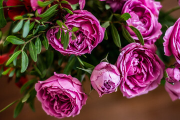 Delicate blossoming pink, white  flowers, blooming roses festive background, flower bouquet pastel image, soft petal. On dark grey rustic wooden background. Roses flowers background
