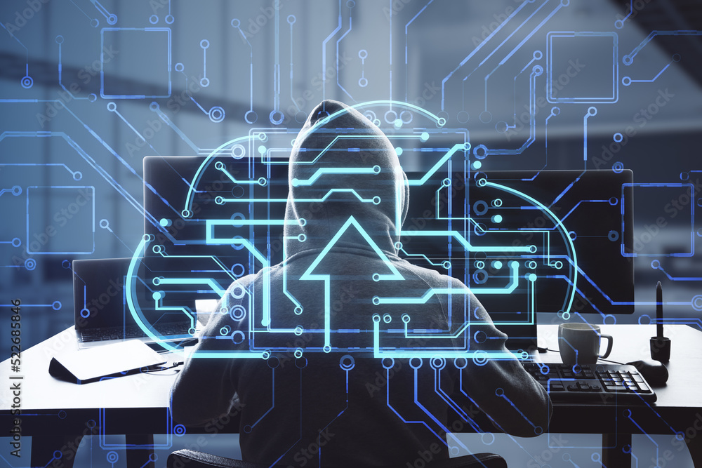 Poster hacker at desktop using laptop computer monitors with abstract glowing circuit cloud hologram on blurry office interior background. Big data, data theft and technology concept. Double exposure.