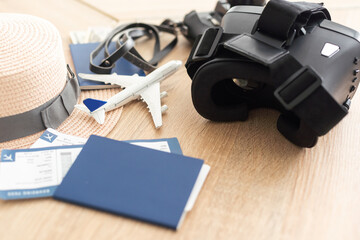 Obraz na płótnie Canvas passport, tickets, toy plane, camera, virtual glasses. virtual reality