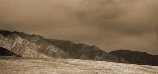 Beautiful landscape of Altay region, Siberia, Russia. Alpine valley in Altay with ridges and snow-capped peaks, the slopes are covered with dense forest