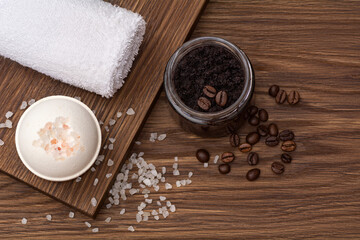 Fototapeta na wymiar Bars of beautiful natural handmade coffee scrub, salt and bomb on a brown wooden background