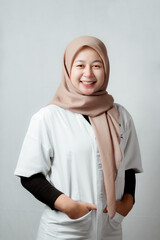 Fototapeta premium Portrait of friendly and smiling Muslim female nurse. Doctor. Young nurse woman wearing hijab.