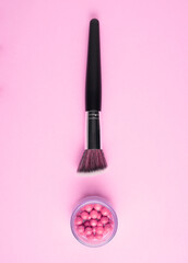 Creative concept beauty fashion photo of cosmetic product make up brushes kit on pink background.