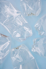 Empty rumpled used plastic bottle on blue background. Top view, copy space. Pollution, environmental protection concept. Reuse garbage, recycle, plastic free. Earth, world water day