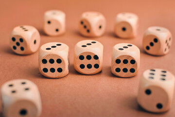 closeup shot of wooden dices with numbers on brown background 