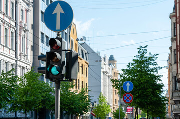 traffic semaphore with green light on the background of defocused urban street