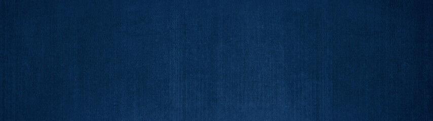 Abstract dark blue colored rustic concrete wall texture background banner panorama with vertical...