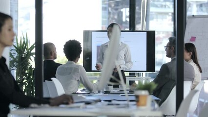 Manager, leader and boss in a presentation, training seminar or teaching workshop in an office meeting in the boardroom. Business woman talking, planning and discussing with colleagues and coworkers