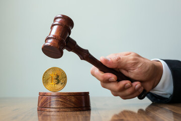 Judge gavel and bitcoin. Cryptocurrency legislation. Bitcoin ban. Violation of law