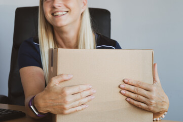 Woman in the office preparing parcel for dispatch