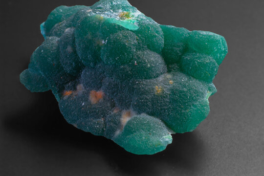 Macro natural Cuprian Adamite isolated on dark grey black background  