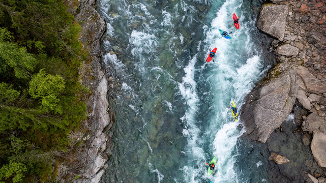 Group of friends spending time on the river enjoying kayaking and rafting together