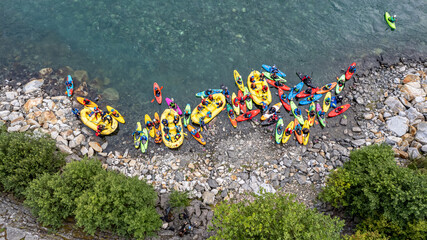 Group of friends spending time on the river enjoying kayaking and rafting together